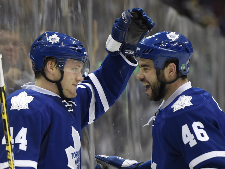 Toronto Maple Leafs' Morgan Rielly, left, celebrates his goal against the Edmonton Oilers with teammate Roman Polak during second period NHL action in Toronto on Saturday, Feb. 7, 2015.