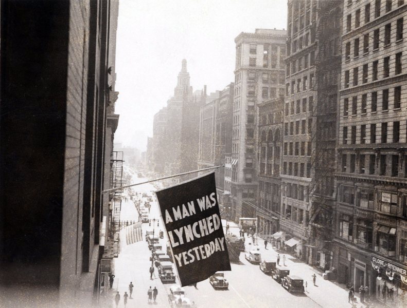 Flag announcing another lynching. 'A MAN WAS LYNCHED YESTERDAY,' is flown from the window of the NAACP headquarters on 69 Fifth Ave., New York City in 1936.