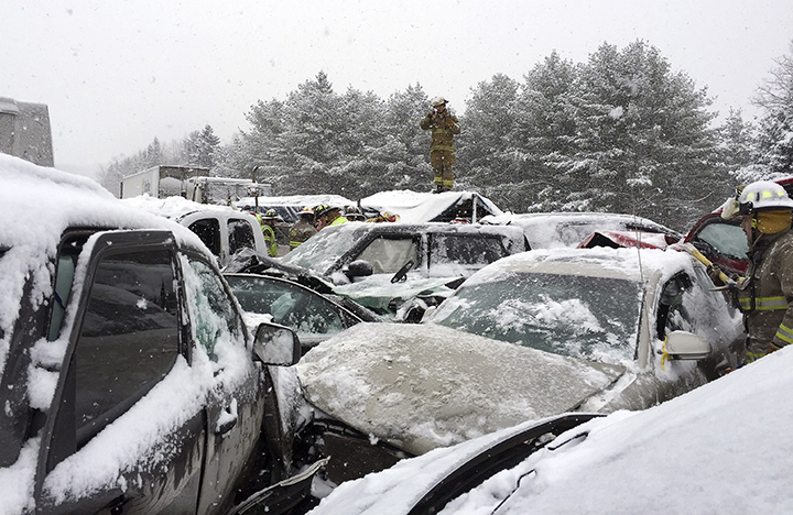 In this photo provided by Maine State Police And Maine Emergency Management, emergency personnel respond to a multi vehicle pileup along Interstate 95 in Enta, Maine, about 20 miles west of Bangor, Wednesday, Feb. 25, 2015.