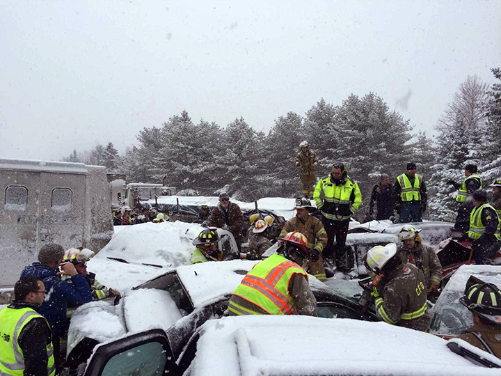 In this photo provided by Maine State Police And Maine Emergency Management, emergency personnel respond to a multi vehicle pileup on Interstate 95 near Bangor, Maine, Wednesday, Feb. 25, 2015.