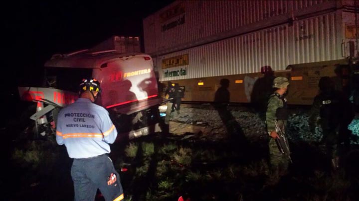 Army soldiers and civil protection workers on the scene of an accident where a passenger bus and a freight train collided at a grade crossing, in Anahuac, Mexico, Friday, Feb. 13, 2015. 