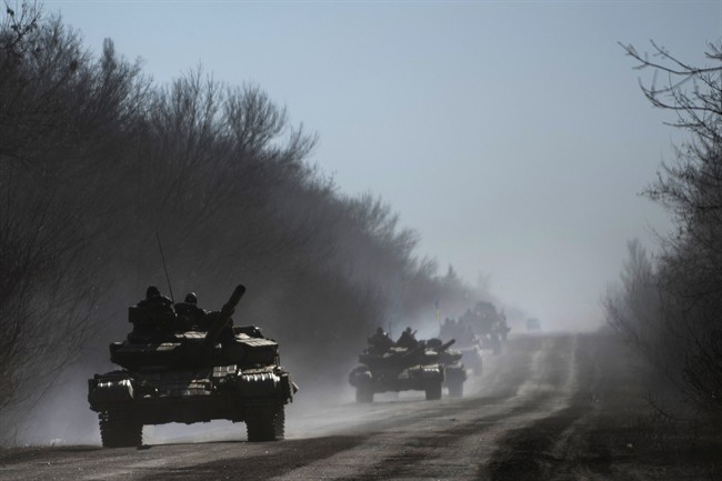 Ukrainian troops ride on tanks near Artemivsk, eastern Ukraine, Tuesday, Feb. 24, 2015.