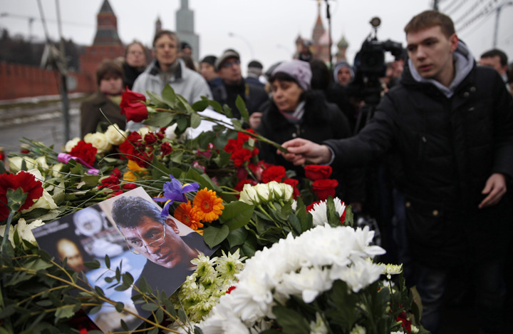 A memorial grows at the spot where Boris Nemtsov, a charismatic Russian opposition leader and sharp critic of President Vladimir Putin, was gunned down, at Red Square in Moscow, Russia, Saturday, Feb. 28, 2015.
