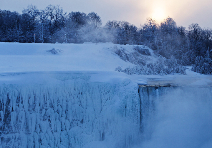 The sun rises over masses of ice formed around Horseshoe Falls.