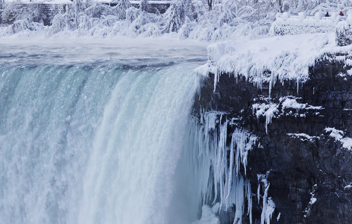 Water still flows, though ice has accumulated around the falls.