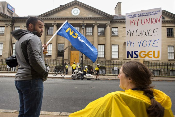 Protesters wait outside the Nova Scotia legislature in Halifax on Sept. 30, 2014.