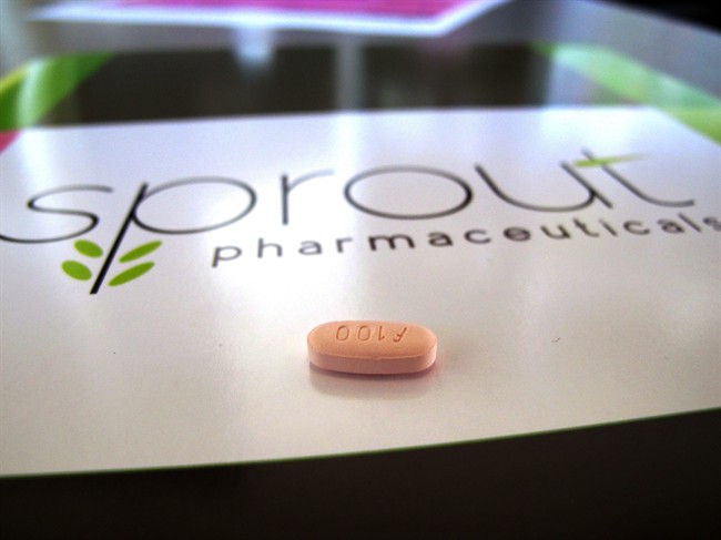 In this Friday, Sept. 27, 2013, file photo, a tablet of flibanserin sits on a brochure for Sprout Pharmaceuticals in the company's Raleigh, N.C., headquarters.