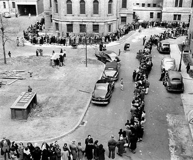 In this April 14, 1947 file photo, a long line winds toward the entrance to Morrisania Hospital in the Bronx borough of New York, where doctors are inoculating against smallpox. In an attempt to halt the spread of the disease, officials said city residents were being vaccinated at the rate of eight a minute. 