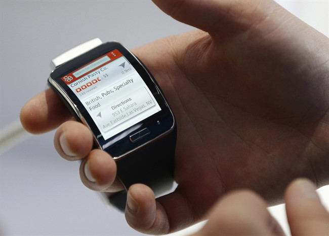 An employee demonstrates the Samsung Gear S smartwatch at the Samsung booth during the International CES in Las Vegas.