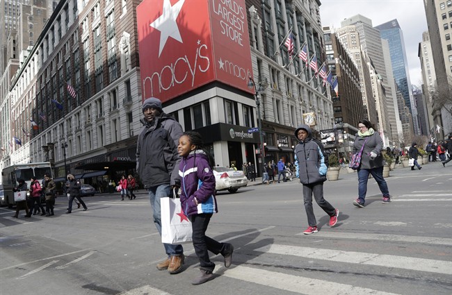 In this Feb. 19, 2015 photo, Macy's shoppers leave the retailer's flagship store, Thursday, Feb. 19, 2015 in New York.