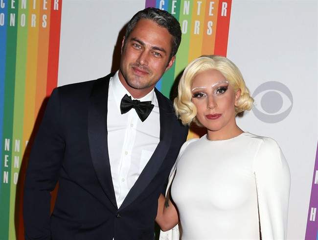 In this Dec. 7, 2014 file photo, Taylor Kinney and Lady Gaga attend the 37th Annual Kennedy Center Honors in Washington. 