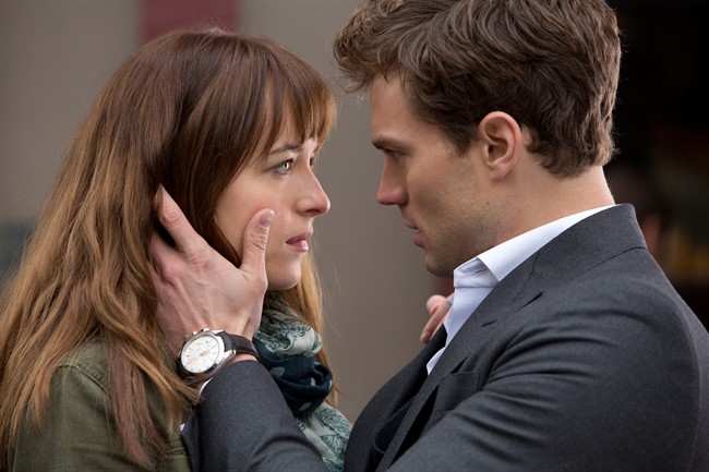 In this image released by Universal Pictures and Focus Features, Dakota Johnson, left, and Jamie Dornan appear in a scene from the film, "Fifty Shades of Grey.".