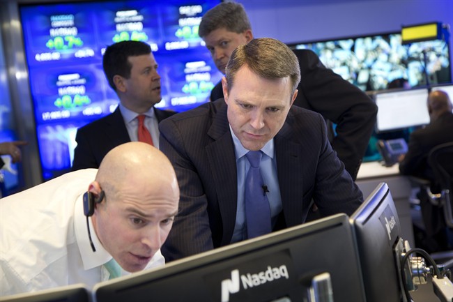 Jay Heller, left, IPO Execution Officer for Nasdaq, shows Keith Dunleavy, CEO of Inovalon, the progress of pricing for his company's stock on computer screens during the Bowie, Maryland health-tech firm's IPO at the Nasdaq MarketSite, Feb. 12, 2015.