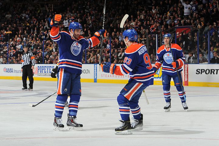 Teddy Purcell #16 and Ryan Nugent-Hopkins #93 of the Edmonton Oilers celebrate after a goal during the game against the Boston Bruins on February 18, 2015 at Rexall Place in Edmonton, Alberta, Canada.