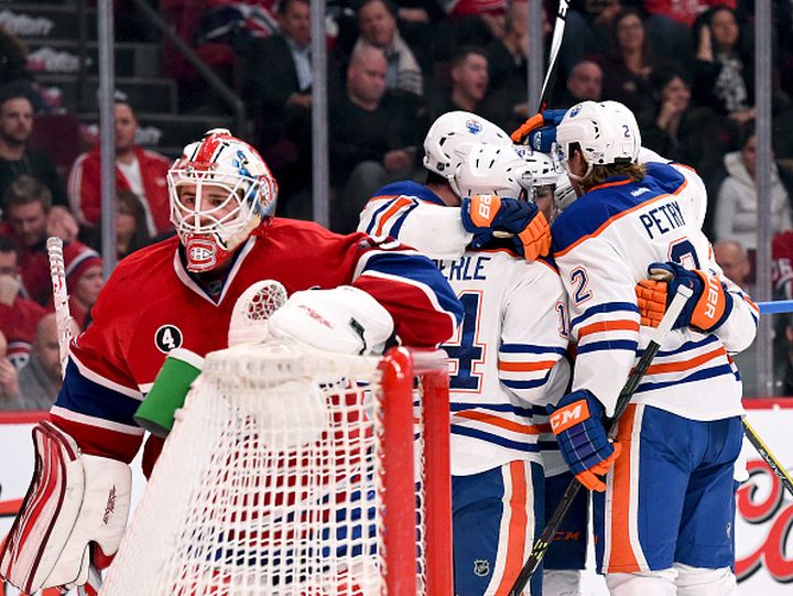 Ryan Nugent-Hopkins #93 of the Edmonton Oilers celebrate with teammates after scoring a goal against the Montreal Canadiens in the NHL game at the Bell Centre on February 12, 2015 in Montreal, Quebec, Canada.