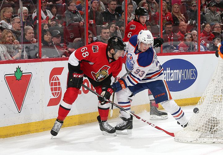 Mike Hoffman #68 of the Ottawa Senators battles for the puck against Ryan Nugent-Hopkins #93 of the Edmonton Oilers in the second period at Canadian Tire Centre on February 14, 2015 in Ottawa, Ontario, Canada. 