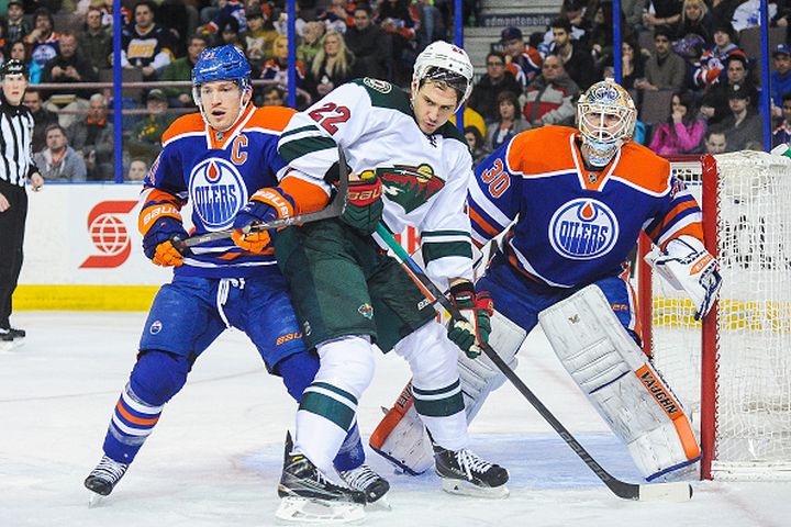 Andrew Ference #21 (L) and Ben Scrivens #30 of the Edmonton Oilers defend net against Nino Niederreiter #22 of the Minnesota Wild during an NHL game at Rexall Place on February 20, 2015 in Edmonton, Alberta, Canada. 