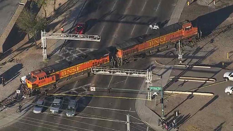 This video frame grab provided by KPHO-TV shows a BNSF Railway train locomotive stopped on a street after hitting a pedestrian in Phoenix, Ariz. 