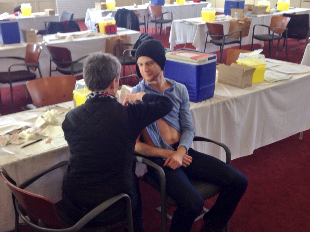 Cameron Ashe, a 4th year student at Acadia University, is the first to get a meningitis vaccination.
