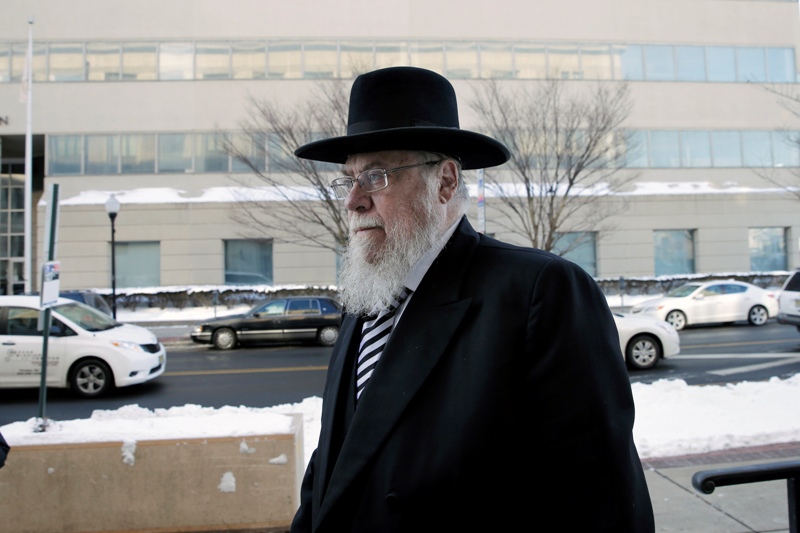 Rabbi Mendel Epstein, right, arrives for his trial at federal court in Trenton, N.J. on Wednesday, Feb. 18, 2015. Prosecutors say Epstein employed a kidnap team to force unwilling Jewish husbands to divorce their wives.
