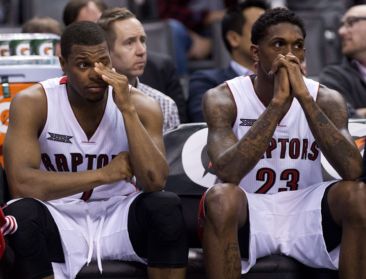 Toronto Raptors guard Kyle Lowry, left, and guard Louis Williams, right, watch from the bench after being defeated by the Brooklyn Nets during second half NBA basketball action in Toronto on Wednesday, February 4, 2015. 