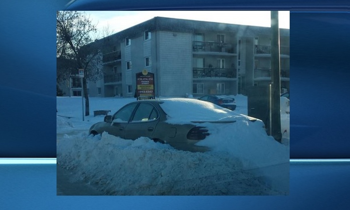 A photo posted to Twitter shows a vehicle that appears to be barricaded by a snowridge on a Regina street.
