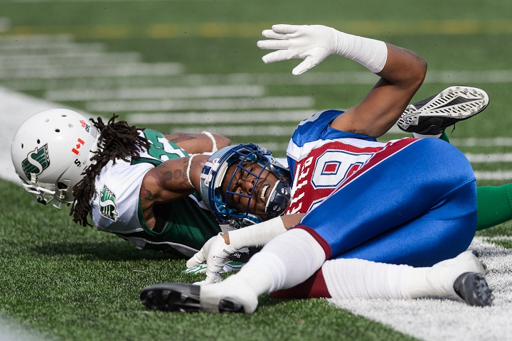 Rod Williams of the Saskatchewan Roughriders tackles Duron Carter #89 of the Montreal Alouettes during the CFL game at Percival Molson Stadium on October 13, 2014 in Montreal.