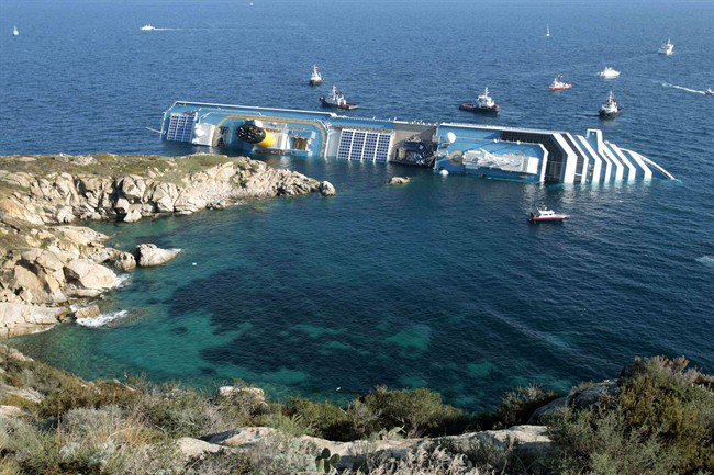 FILE - In this Jan. 14, 2012 file photo the luxury cruise ship Costa Concordia leans on its side after running aground in the tiny Tuscan island of Giglio, Italy. 
