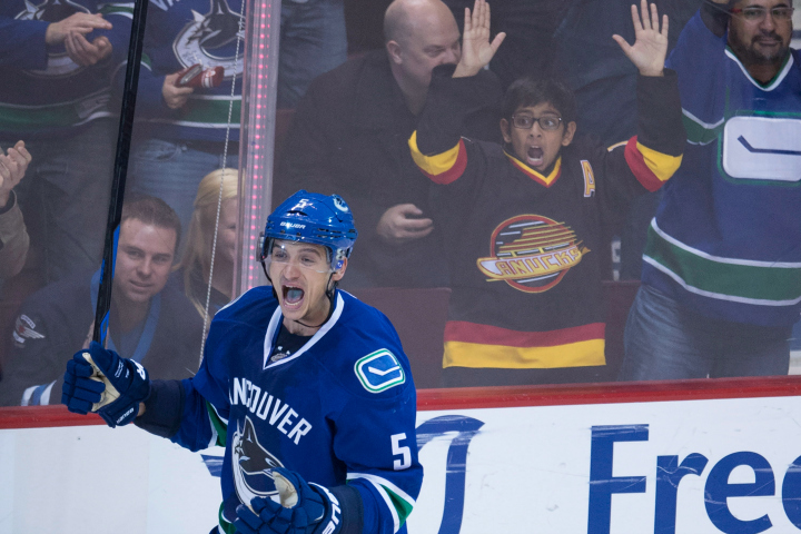 Vancouver Canucks defenceman Luca Sbisa (5) celebrates his game winning goal against the Winnipeg Jets during the overtime period of NHL action in Vancouver, B.C. Tuesday, Feb. 3, 2015. 