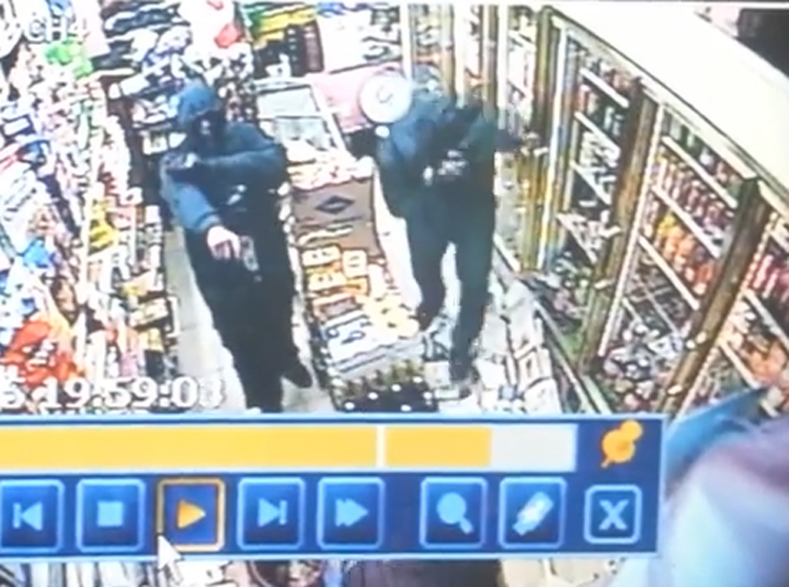 A screenshot of the security camera footage capturing the armed robbery.