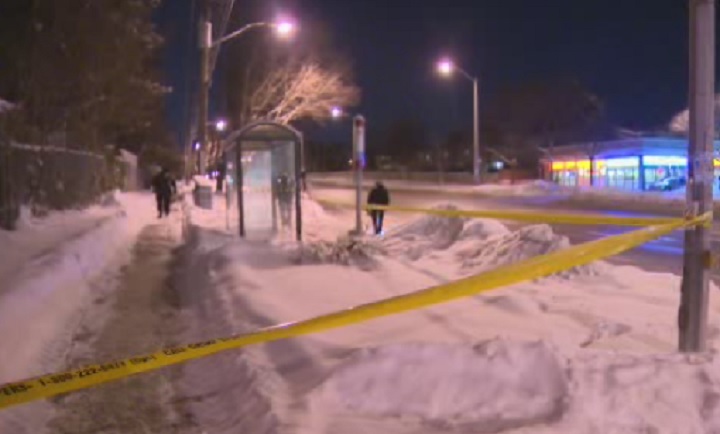 Police investigate a shooting near a bus shelter on Feb. 22, 2015.