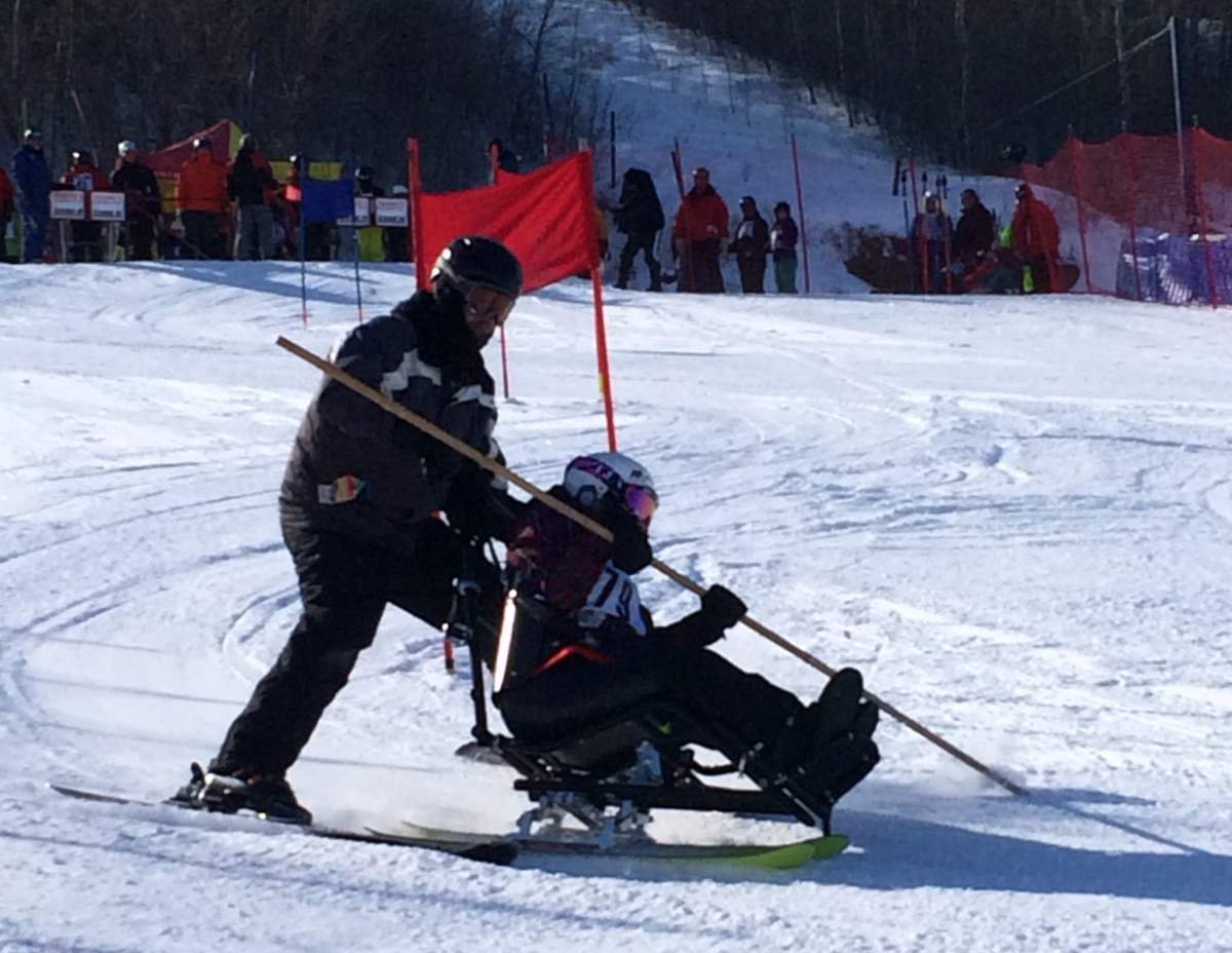 Skylar Derin uses a sit and ski to ride down the  hill at Mission Ridge Winter Park.
