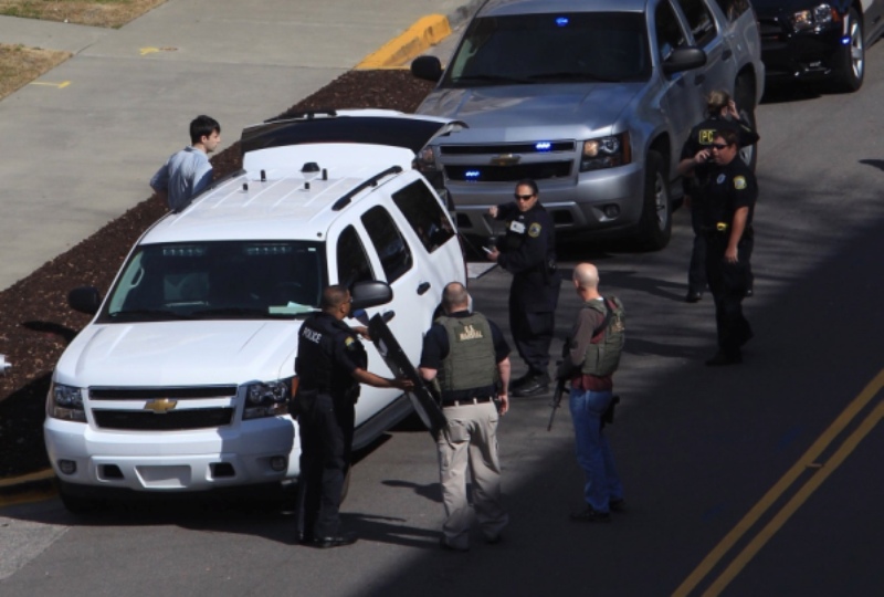 Law enforcement officials gather on the campus of the University of South Carolina in Columbia, S.C., after shots were fired at its new School of Public Health, Thursday, Feb. 5, 2015. There were no immediate reports on injury or suspects.
