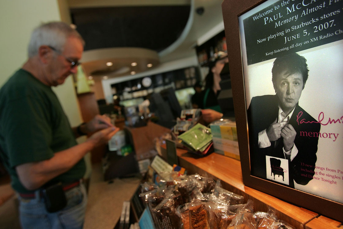 An advertisements for the Paul McCartney CD album 'Memory Almost Full' at a Starbucks store in 2007. Starbucks will end compact disc sales next month.