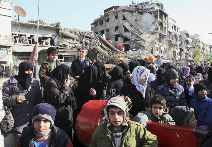 Hundreds of Syrians  wait in line at a military checkpoint in the town of Beit Sahm, south of the capital, Damascus, Syria on Jan. 14, 2015.