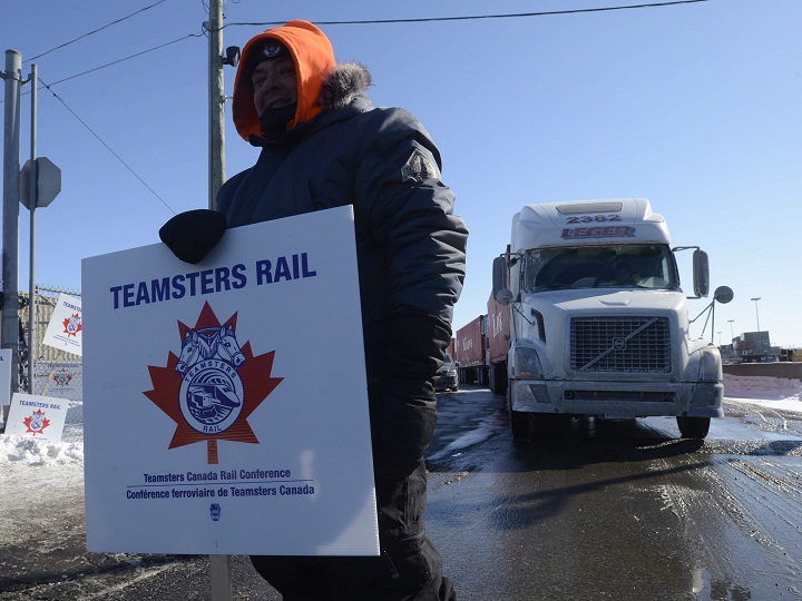 A Canadian Pacific Railway worker walks the picket line while on strike at the Cote Saint-Luc railyard in Montreal on Monday, Feb. 16, 2015.