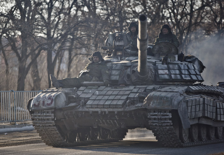 Russia-backed rebels ride on a tank outside Luhansk, Ukraine on Saturday, Feb. 21, 2015. 