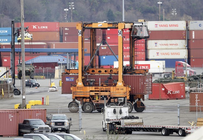 A cargo container is moved at the Port of Tacoma, Friday, Feb. 20, 2015, in Tacoma, Wash. 