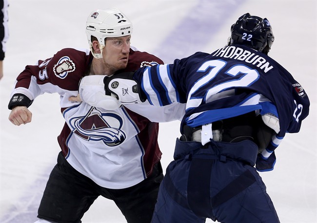 Colorado Avalanche's Cody McLeod fights with Winnipeg Jets' Chris Thorburn during first period NHL hockey action in Winnipeg, in 2015.