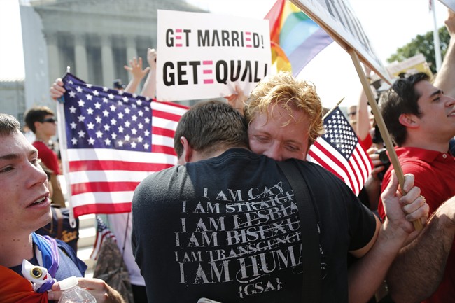 Michael Knaapen, left, and his husband John Becker, right, embrace outside the Supreme Court in Washington on June 26, 2013.