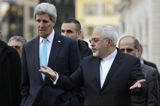 In this Jan. 14, 2015 file picture US Secretary of State John Kerry, left, listens to Iranian Foreign Minister Mohammad Javad Zarif, as they walk in the city of Geneva, Switzerland, during a bilateral meeting ahead of nuclear discussions. 