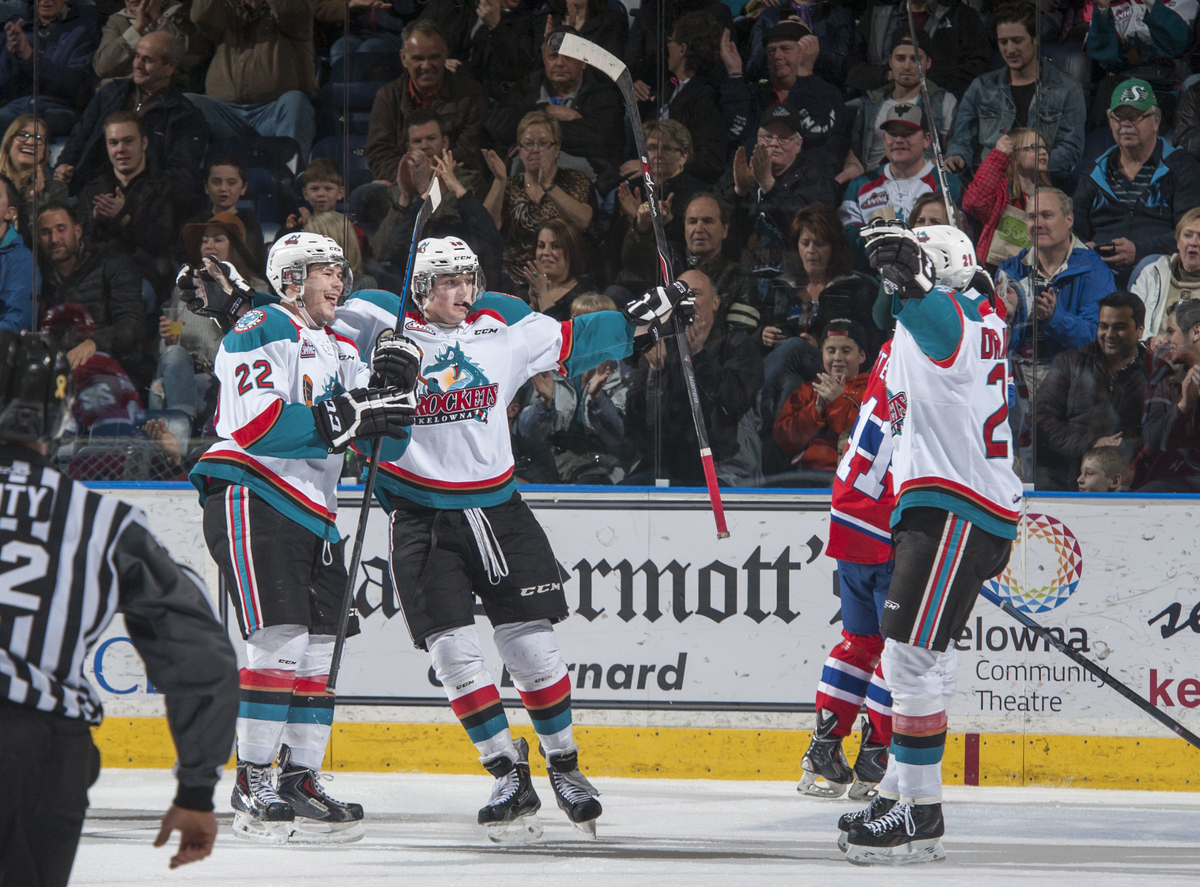 Chance Braid #22, Tomas Soustal #15 and Leon Draisaitl #29 of Kelowna Rockets celebrate a goal against the Spokane Chiefs on March 7, 2015 at Prospera Place .