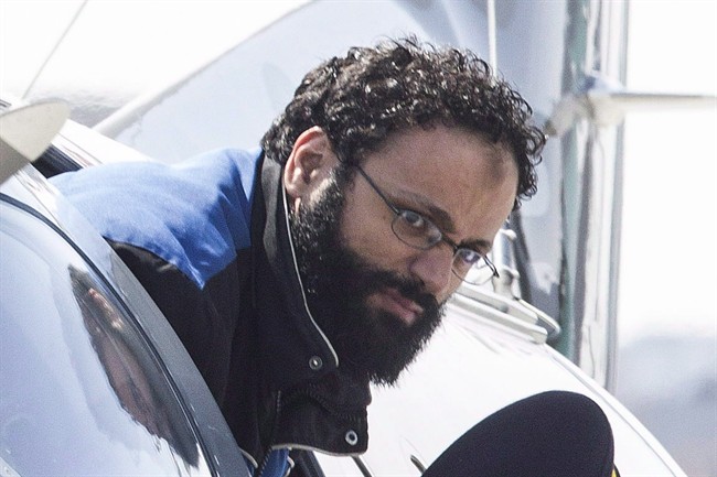 Chiheb Esseghaier, one of two men accused of plotting a terror attack on rail target, is led off a plane by an RCMP officer at Buttonville Airport just north of Toronto on Tuesday April 23, 2013.