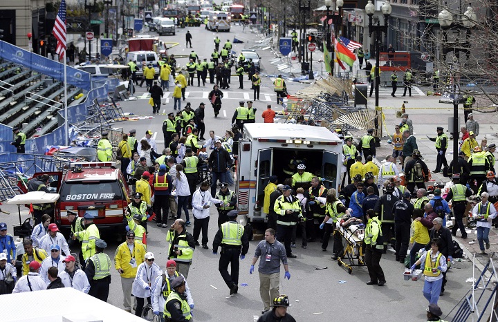 In this April 15, 2013 file photo, medical workers aid injured people at the finish line of the 2013 Boston Marathon following an explosion. 