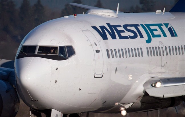 A pilot taxis a Westjet Boeing 737-700 plane to a gate after arriving at Vancouver International Airport.
