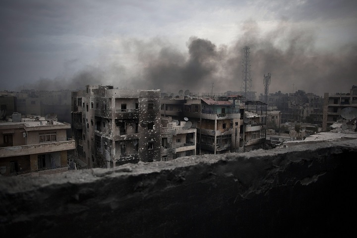 In this Tuesday, Oct. 2, 2012 file photo, smoke rises over Saif Al Dawla district, in Aleppo, Syria. 