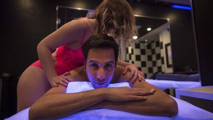 Yanick Chicoine, who operates two erotic massgae parlours in the city's east end, poses for a photograph in a massage parlour,  Wednesday, February 18, 2015 in Montreal. 