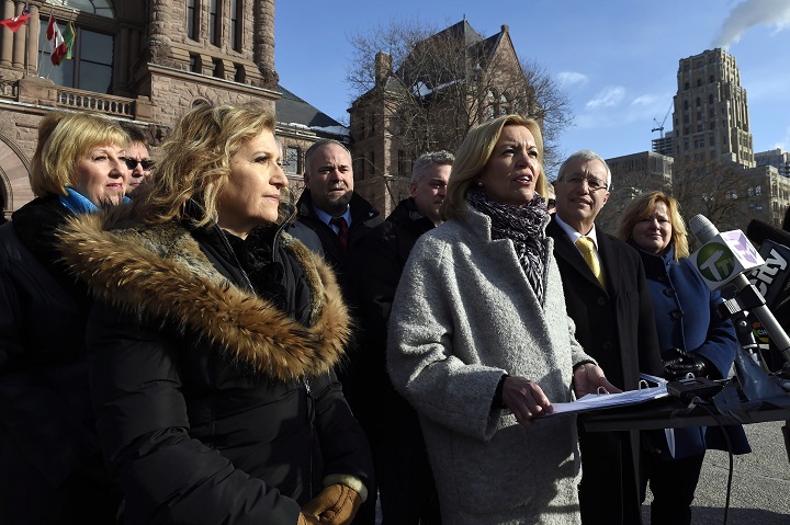 Whitby-Oshawa MPP Christine Elliott, centre, speaks at a news conference at Queen's Park in Toronto on Thursday, March 5, 2015.