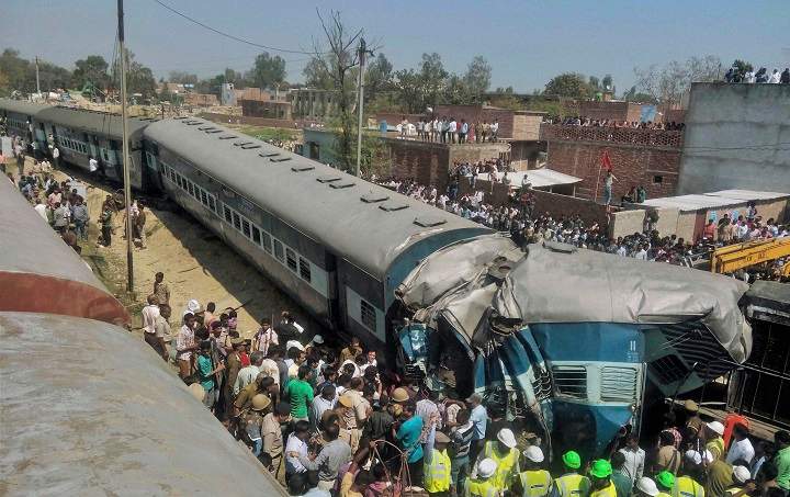 Indian rescue workers gather at the site of a train accident near Bachhrawan village in Uttar Pradesh state, India, Friday, March 20, 2015. Three coaches of a passenger train derailed Friday in northern India.