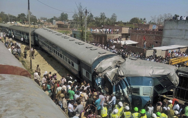 Indian rescue workers gather at the site of a train accident near Bachhrawan village in Uttar Pradesh state, India, Friday, March 20, 2015. Three coaches of a passenger train derailed Friday in northern India.